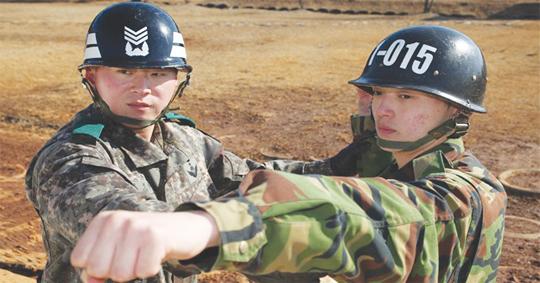 훈련병이 실수로 흘린 수류탄을 피해 훈련병을 구한 육군훈련소 김현수(오른쪽) 소대장이 수류탄 투척 방법과 자세를 지도하고 있다.  사진=육군본부 제공
