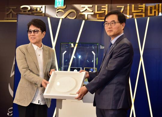 한국조폐공사는 23일 롯데호텔 서울에서 `조용필 50주년 기념메달`을 공개했다. 가왕 조용필(왼쪽)과 조폐공사 조용만 사장이 기념메달 석고판을 들고 기념촬영하고 있다. 사진=조폐공사 제공
