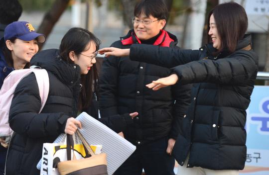 2019학년도 대학수학능력시험이 실시된 15일 대전복수고등학교 고사장 앞에서 한 수험생이 선생님의 응원을 받으고 고사장에 들어서고 있다. 빈운용 기자 

