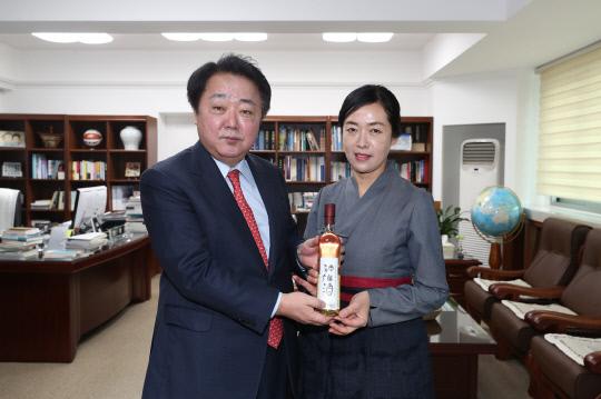 21일 청주신선주 이수자 박준미(오른쪽) 씨가 한범덕 청주시장에게 출시 기념 청주신선주를 전달했다. 사진=청주시 제공
