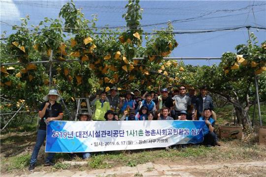 대전시설관리공단 직원들이 지난 18일 일손이 부족한 과수농가를 찾아 사회공헌활동을 실시하고 있다. 사진=대전시설관리공단 제공

