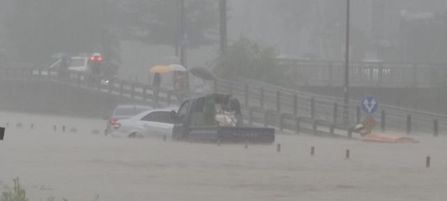 3일 폭우로 천안 충무로 신방삼거리 주변 도로에서 자동차가 물에 잠겨 있다. 사진=윤평호 기자